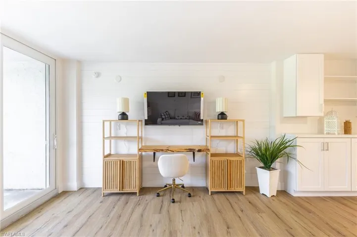 Office space featuring light wood-type flooring and wooden walls