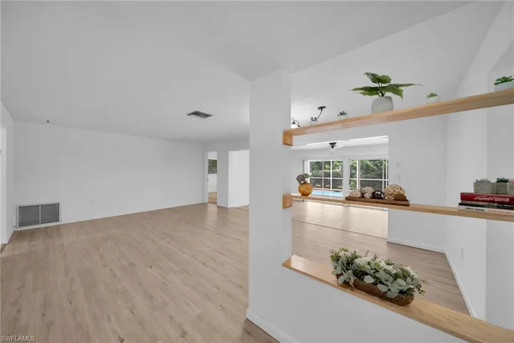 Living area featuring light wood-style flooring and baseboards