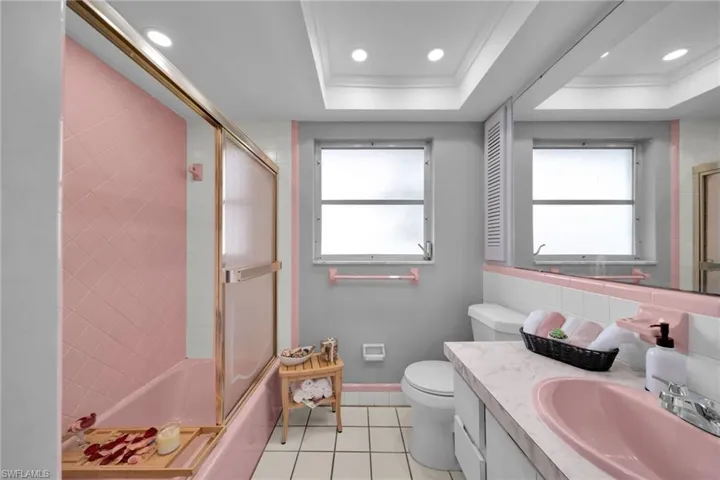 Full bathroom with vanity, shower / bath combination with glass door, light tile patterned floors, recessed lighting, and ornamental molding
