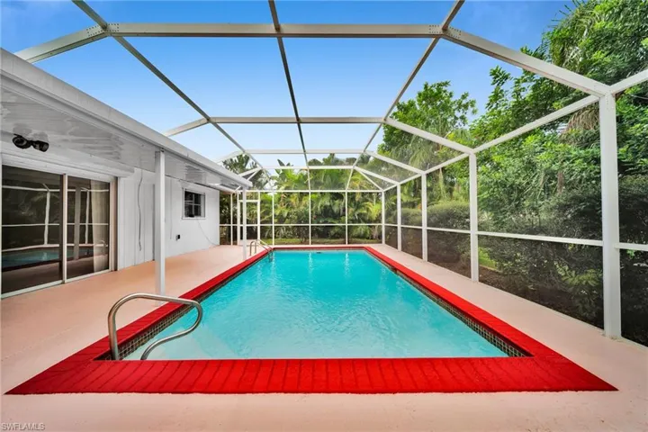 Swimming pool with a lanai and a sunroom