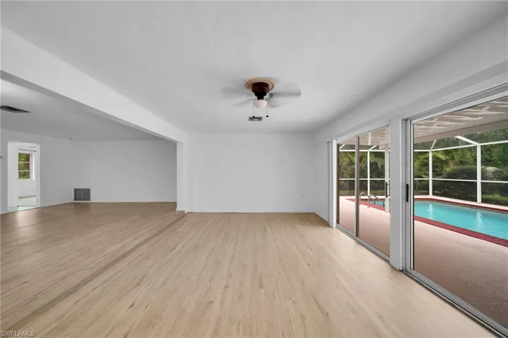 Unfurnished living room with light wood-style flooring and ceiling fan