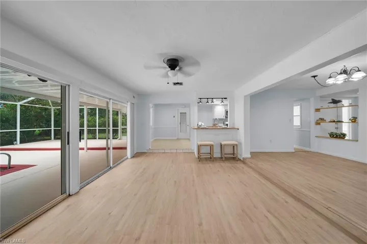 Unfurnished living room with light wood-type flooring and ceiling fan