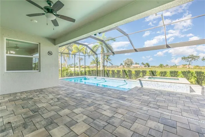 View of swimming pool with a patio, a lanai, a sunroom, ceiling fan, and a pool with connected hot tub