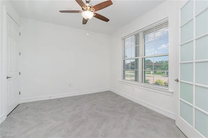 Unfurnished room with baseboards and a ceiling fan