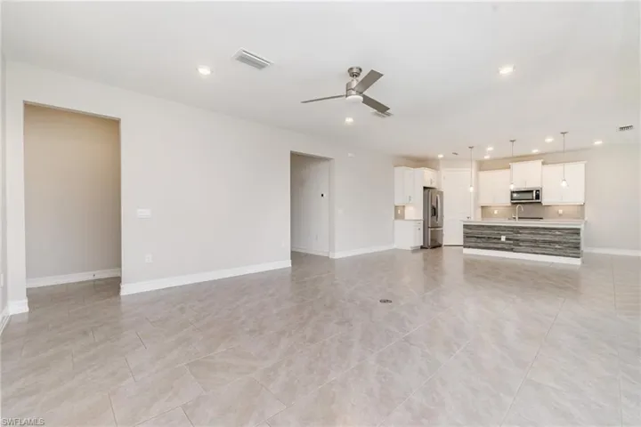 Unfurnished living room with recessed lighting, ceiling fan, and light tile patterned floors