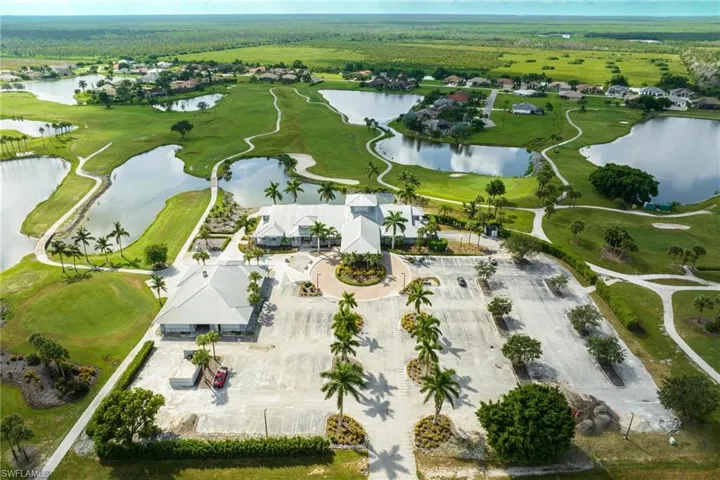 Aerial perspective of suburban area featuring a large body of water and a local golf course