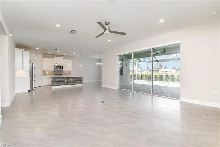 Unfurnished living room featuring a ceiling fan, recessed lighting, a sunroom, and light tile patterned floors