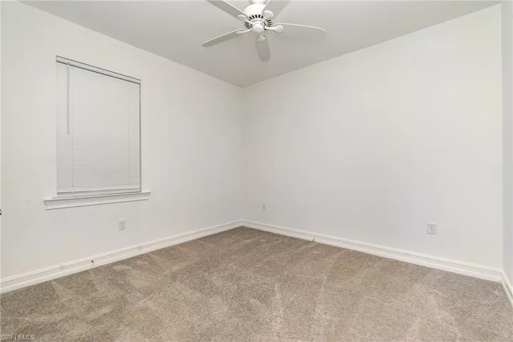 Spare room with carpet floors and a ceiling fan