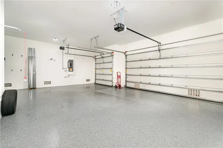 Garage with a garage door opener and electric panel