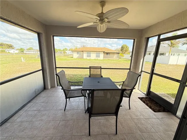 Sunroom / solarium featuring a ceiling fan, outdoor dining space, and healthy amount of natural light