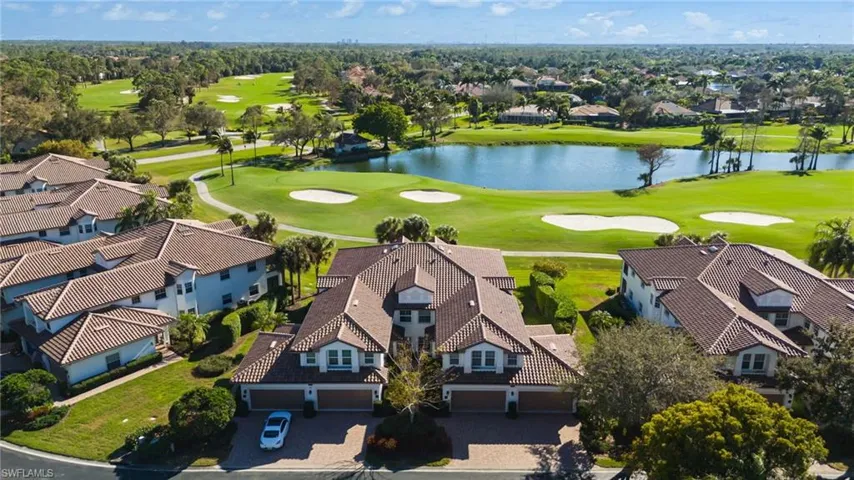 Aerial view of residential area with a local golf course and a nearby body of water