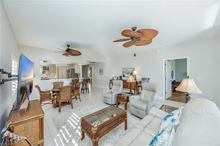 Living room with a ceiling fan and baseboards