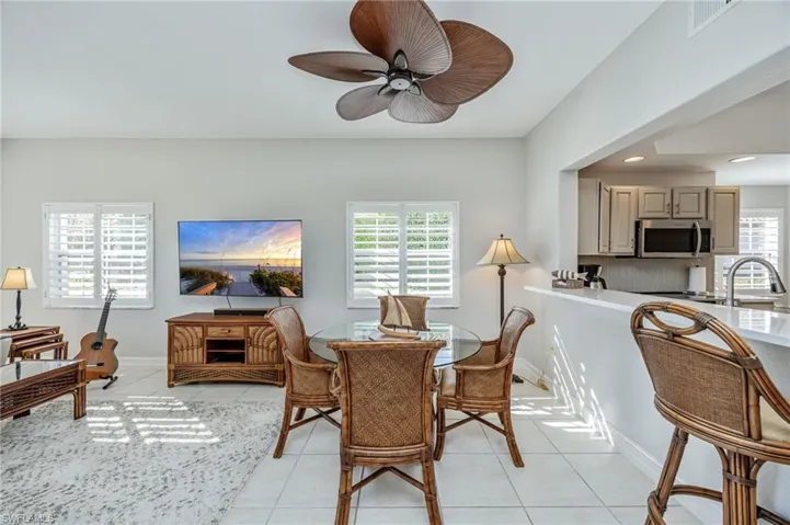 Dining space featuring light tile patterned floors, ceiling fan, and recessed lighting