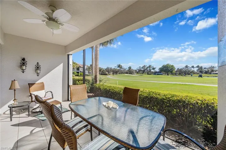 Sunroom with ceiling fan, outdoor dining area, a patio, and view of golf course