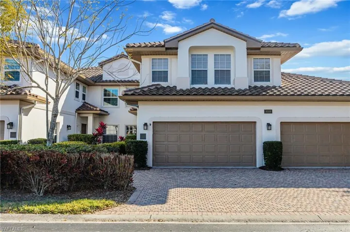 Mediterranean / spanish house featuring stucco siding, decorative driveway, and a tiled roof