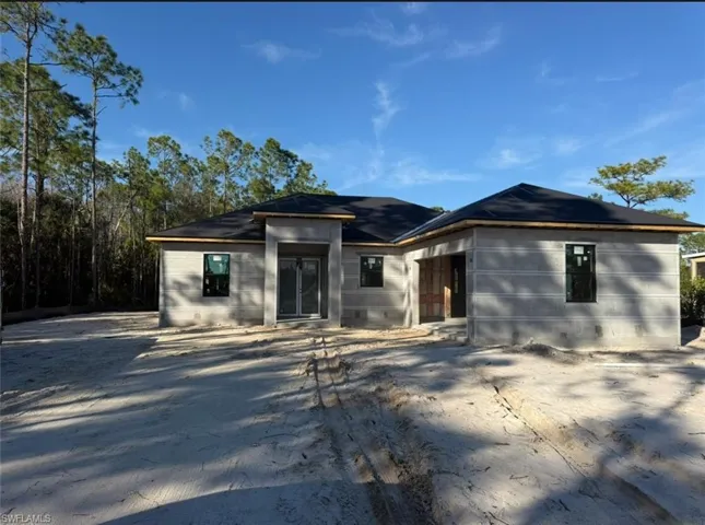View of front of house featuring concrete block siding