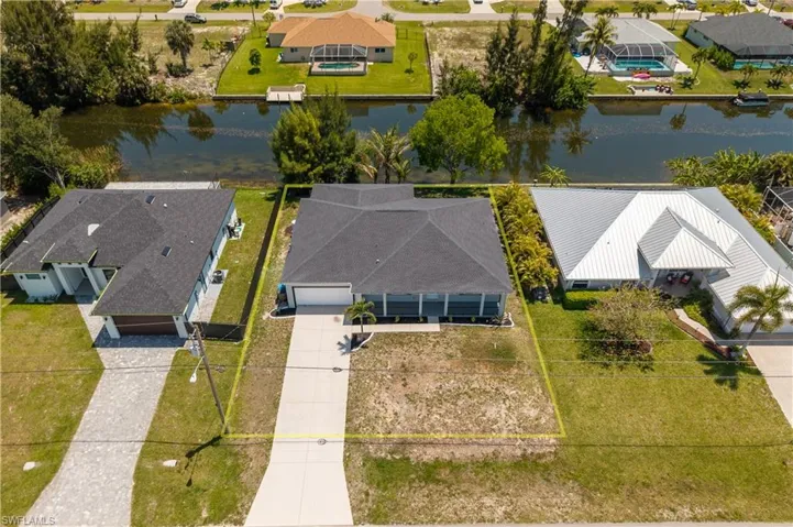 Contemporary-style property featuring a dark shingle roof and a concrete driveway