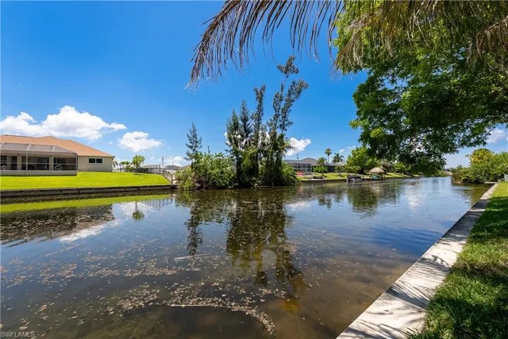 Waterfront property featuring a screened lanai and direct canal access