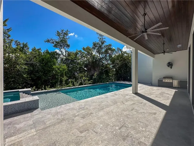 Large Lanai with a built in grill with custom cabinets