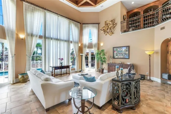 Living room featuring a high ceiling and light tile floors