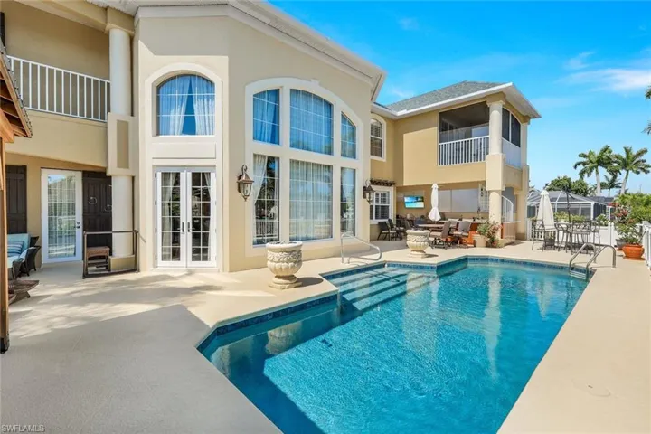 View of pool with french doors and a patio