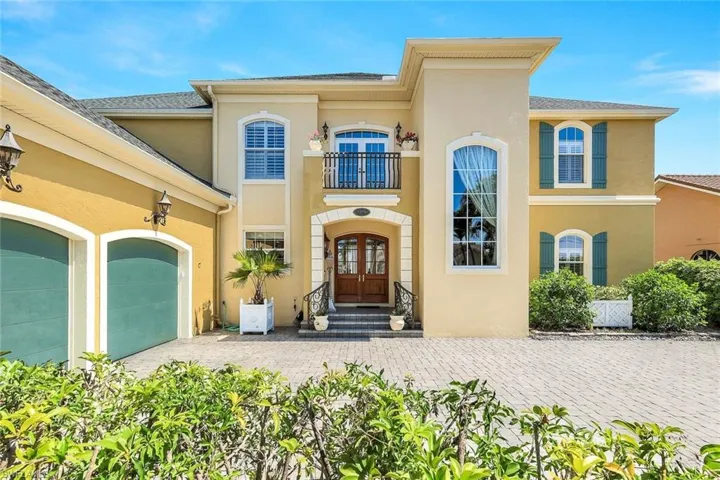 Mediterranean / spanish-style home with a balcony and french doors