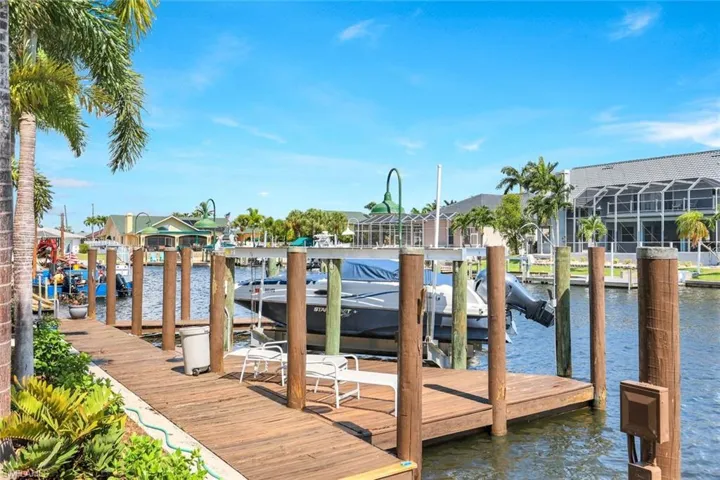 Dock featuring a lanai and a water view