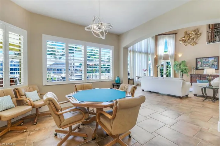 Dining area with a chandelier and light tile floors