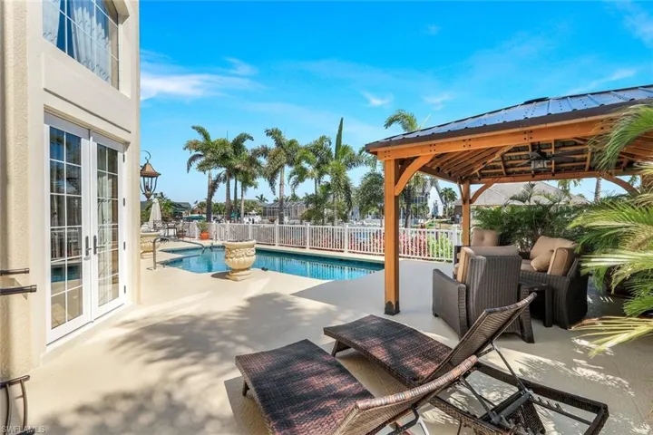 View of swimming pool featuring a patio area and a gazebo