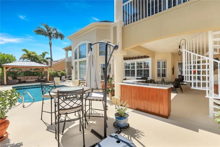 View of terrace with an outdoor bar and a gazebo