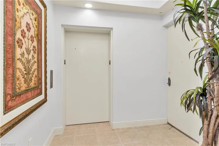 Entrance foyer featuring light tile floors