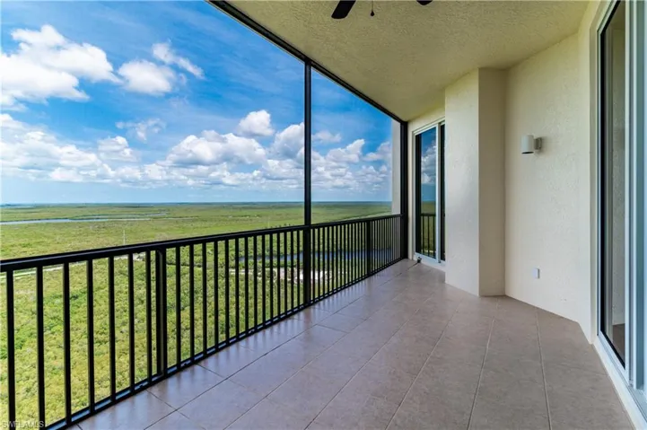 Unfurnished sunroom featuring a rural view and ceiling fan