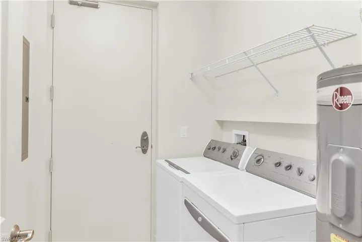Clothes washing area with electric water heater, hookup for a washing machine, and washing machine and clothes dryer