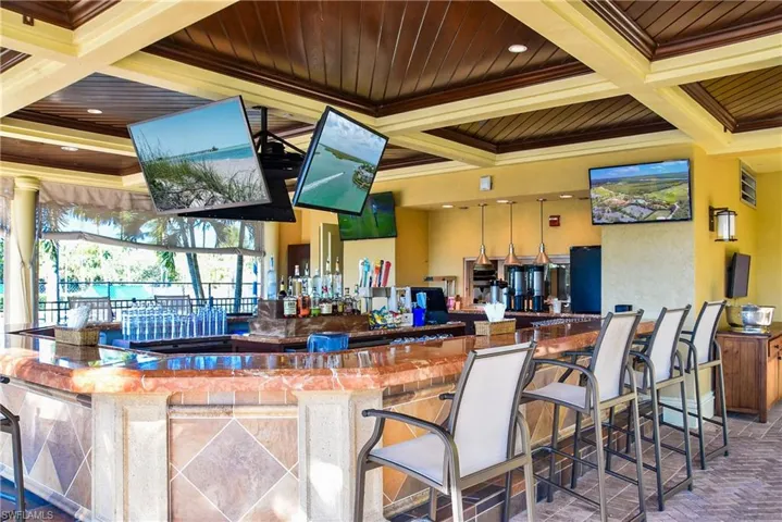 Bar with wooden ceiling, beamed ceiling, coffered ceiling, and crown molding