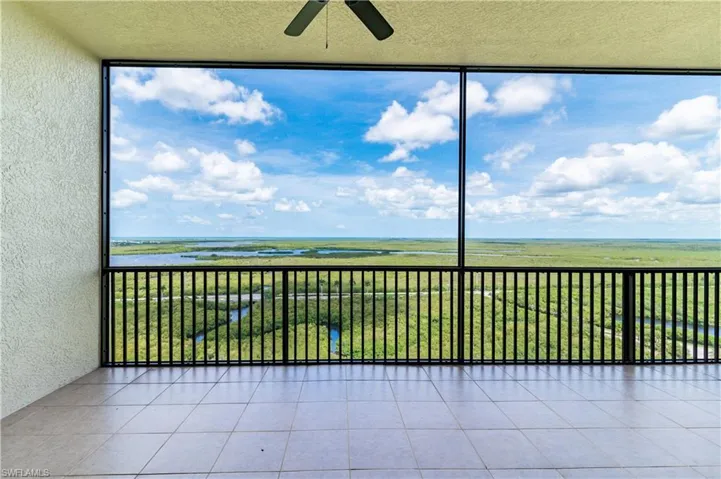 Unfurnished sunroom with ceiling fan