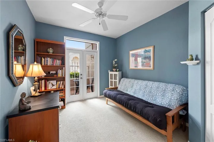 Living area featuring french doors, carpet, an office area, and a ceiling fan