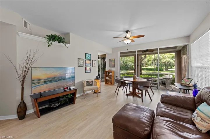 Living area featuring light wood-type flooring and ceiling fan