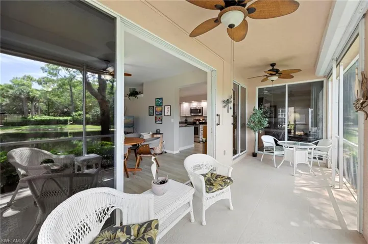 Sunroom with a ceiling fan and a wooden deck
