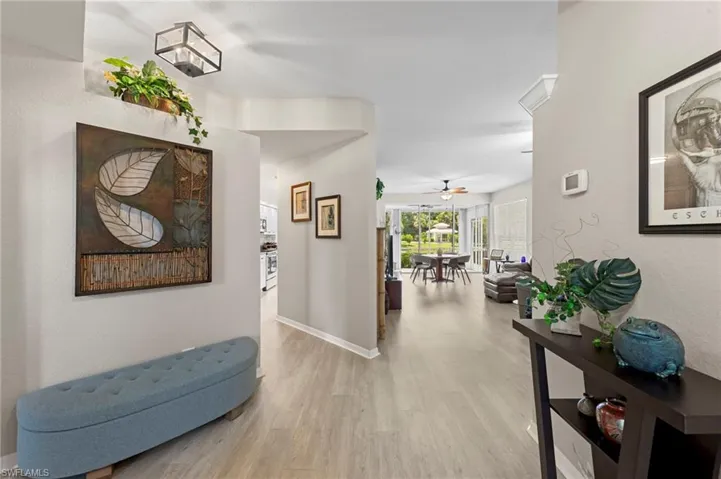 Corridor with light wood-style floors and baseboards