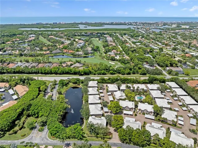 View of property location featuring a large body of water, nearby suburban area, and a local golf course