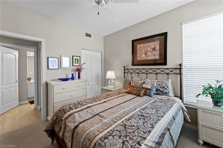 Bedroom with carpet, a closet, and ceiling fan