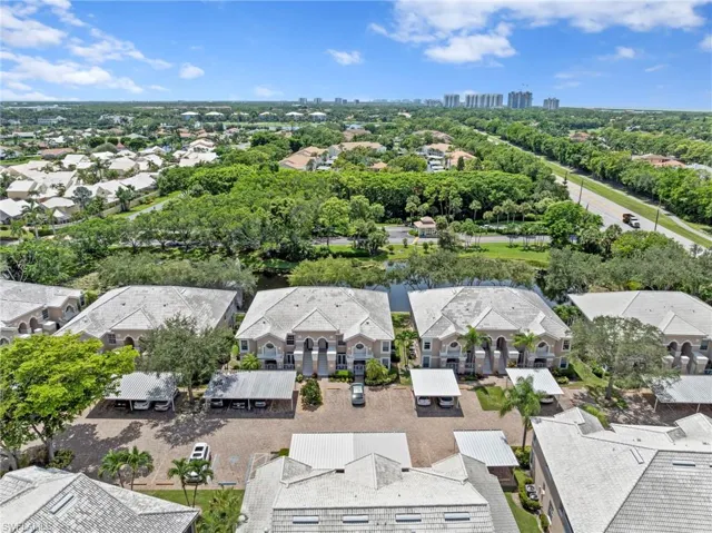 Aerial perspective of suburban area with skyline and a tree filled landscape