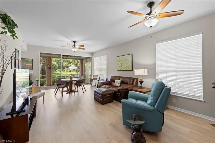 Living area featuring a ceiling fan and light wood finished floors