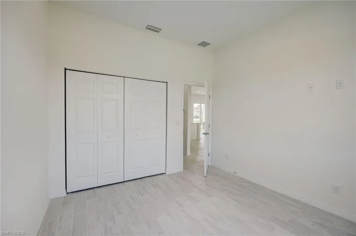 Unfurnished bedroom featuring light hardwood / wood-style floors and a closet