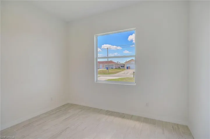 Empty room with light hardwood / wood-style floors