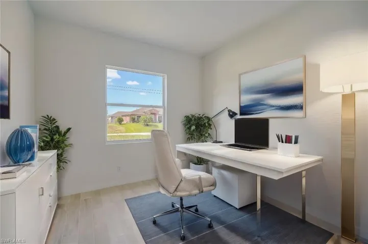 Home office with hardwood / wood-style floors