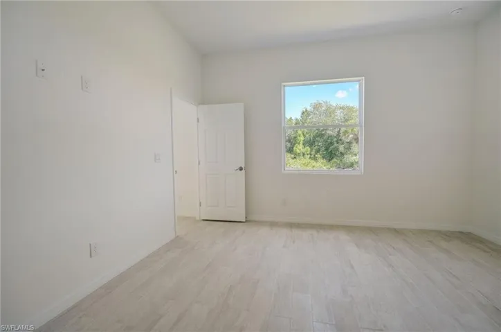 Unfurnished room with light wood-type flooring