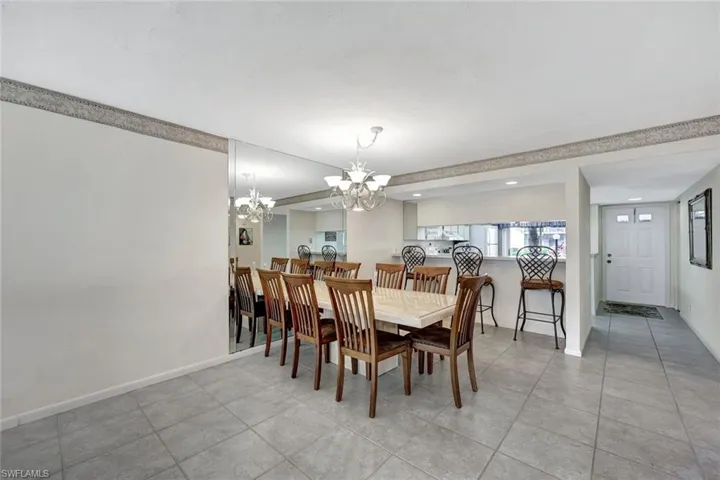 Dining area featuring a chandelier and light tile patterned floors