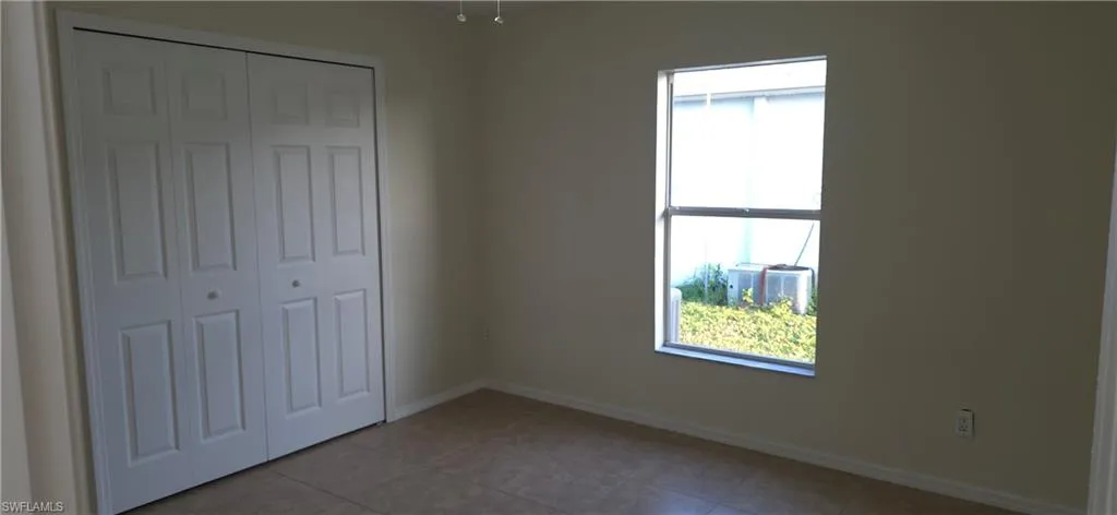 Unfurnished bedroom featuring a closet and tile patterned floors