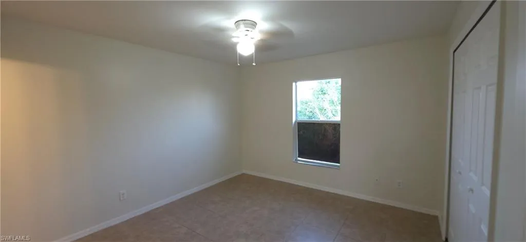 Unfurnished bedroom featuring a closet and a ceiling fan